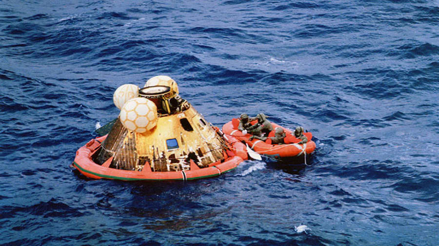 The Apollo 11 crew and a Navy diver await pickup after splashdown in the Pacific Ocean on July 24, 1969. (Image: NASA)