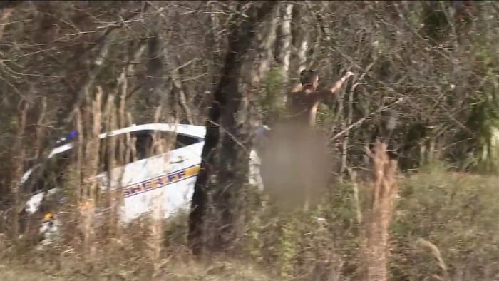 Naked man driving stolen JSO cruiser crashes into woods on I-10