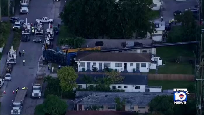 Massive crane falls in between houses in northeast Miami Dade