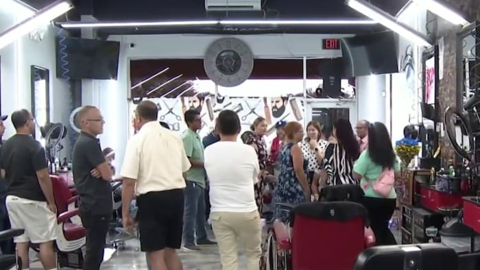 Community family gather to mourn Kissimmee barber who was found dead in a submerged vehicle