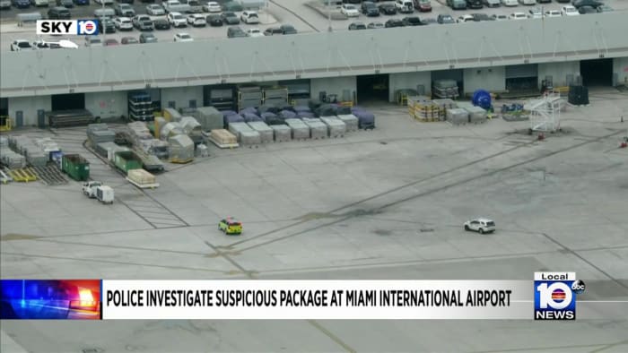 Police officers evacuate cargo building at Miami International Airport