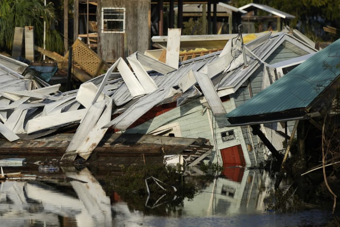 Residents pick through the rubble of lost homes and scattered belongings in  Hurricane Idalia's wake