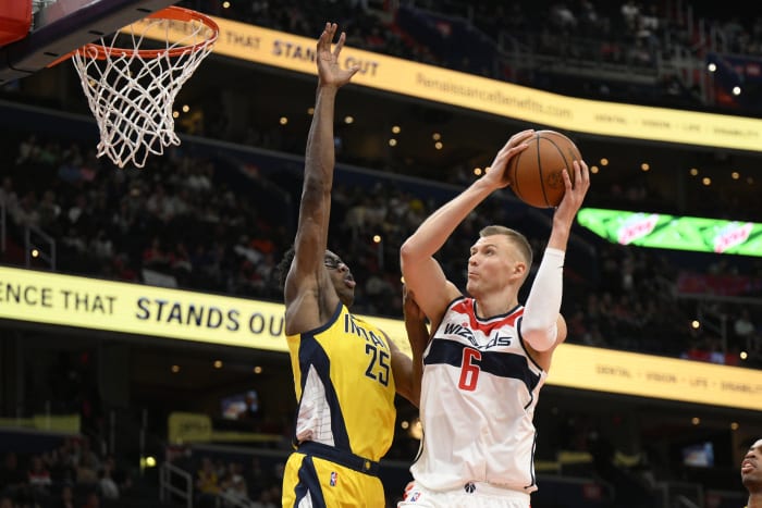 Los Angeles Clippers guard Paul George, left, dunks the ball against  Indiana Pacers guard Justin Holiday, back, during the first quarter of an  NBA basketball game, Sunday, Jan. 17, 2021, in Los