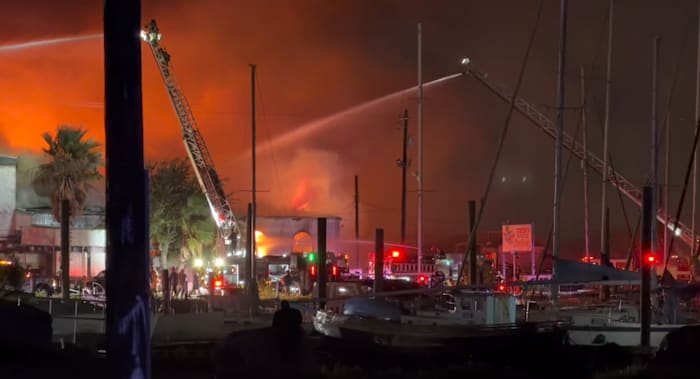 Image linked from the original feed: Large fire burning at building near Galveston Yacht Basin