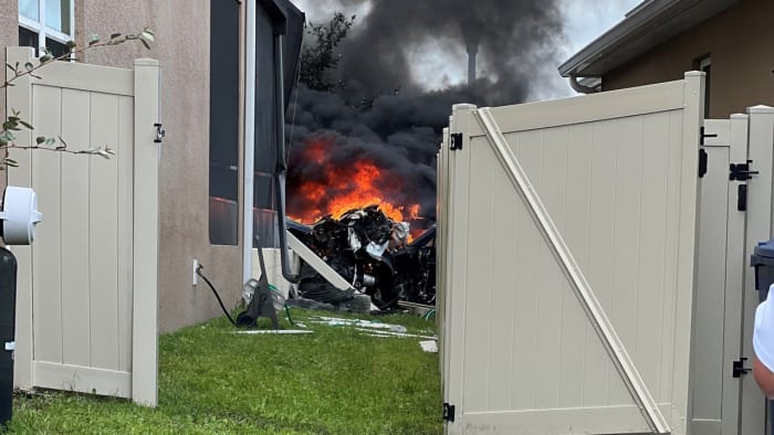 PHOTOS: Tesla bursts into flames after slamming into Florida home PHOTOS: Tesla bursts into flames after slamming into Florida home