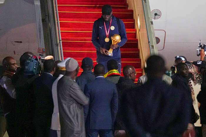 Senegal President greets team as triumphant players receive heroes welcome in Dakar