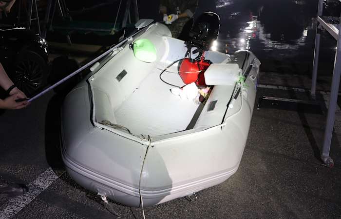 A Chinese dissident is in South Korean custody after a perilous escape by rubber boat