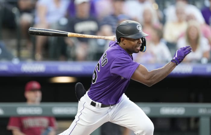 Injured Colorado Rockies outfielder Charlie Blackmon warms up