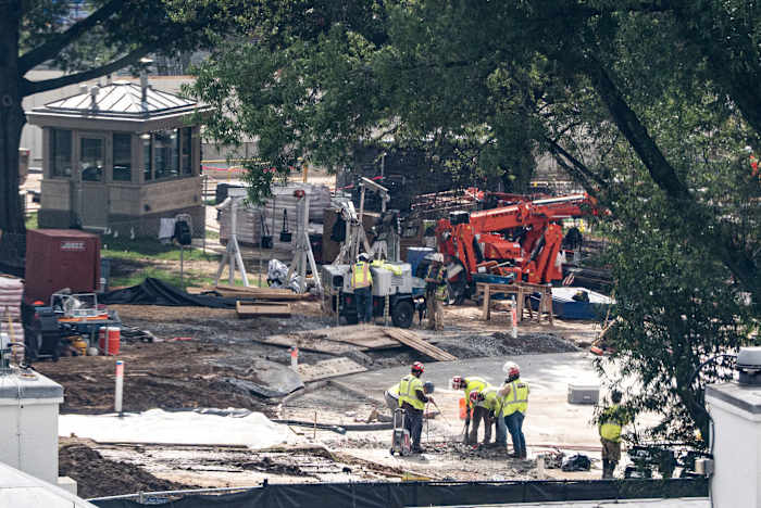 Image linked from the original feed: Crews remove the granite seal on the White House helipad, signaling potential project delays