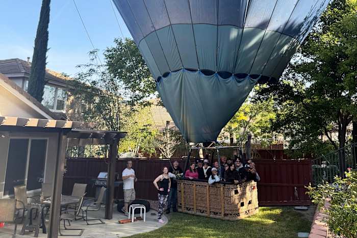 Mind if we drop in? Hot air balloon with 13 aboard makes emergency ...