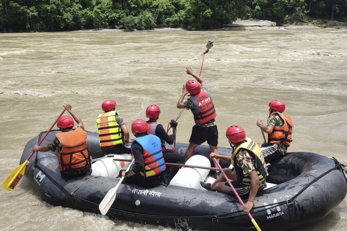 Rescuers in Nepal recover 7 bodies after a landslide swept 2 buses of people into a river