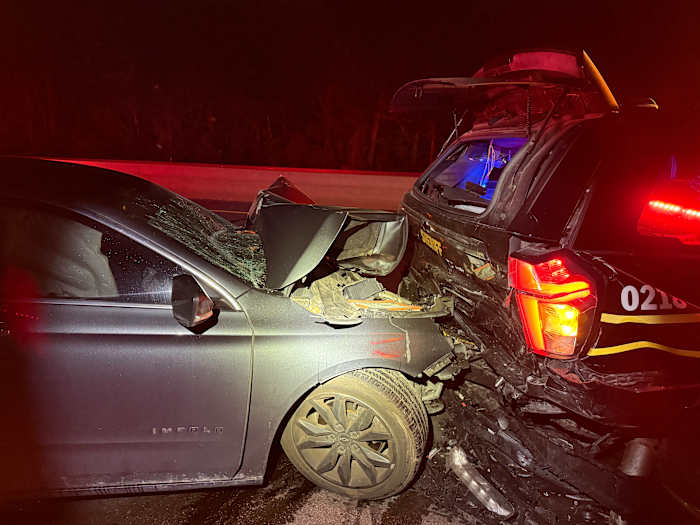 Driver critically injured after crashing into parked patrol vehicle on M-59