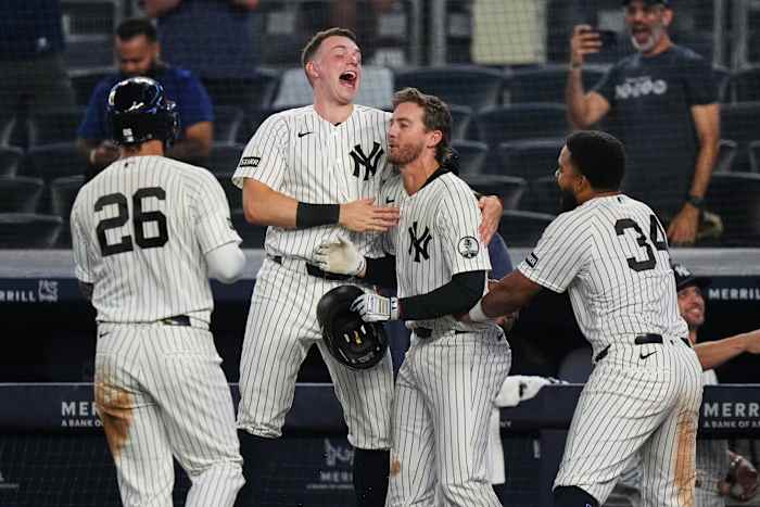Yankees rally with 2 outs in 9th inning and beat Braves 3-2 in 10 after long rain delay