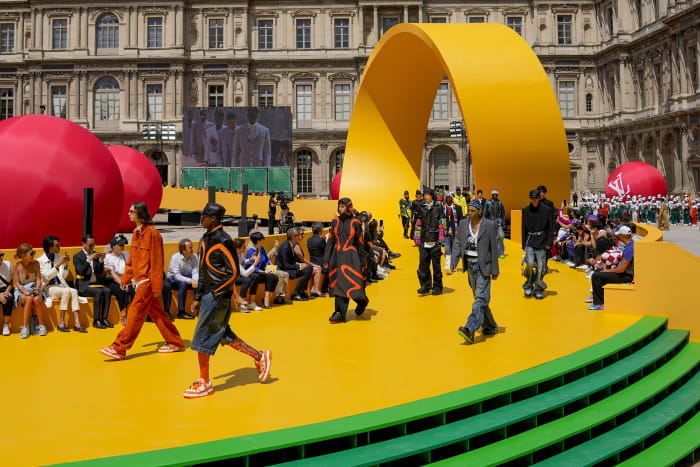 Louis Vuitton inserts a yellow racetrack at the Louvre for Spring Summer  2023 show