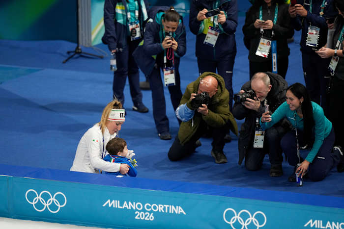Francesca Lollobrigida hugs her son after winning Italy's first gold of the Milan Olympics