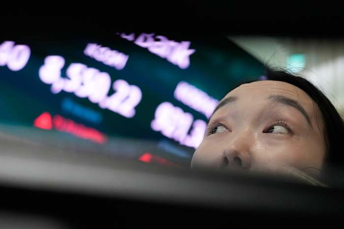 Global shares trade mixed while the dollar hits a 40-year high against the yen