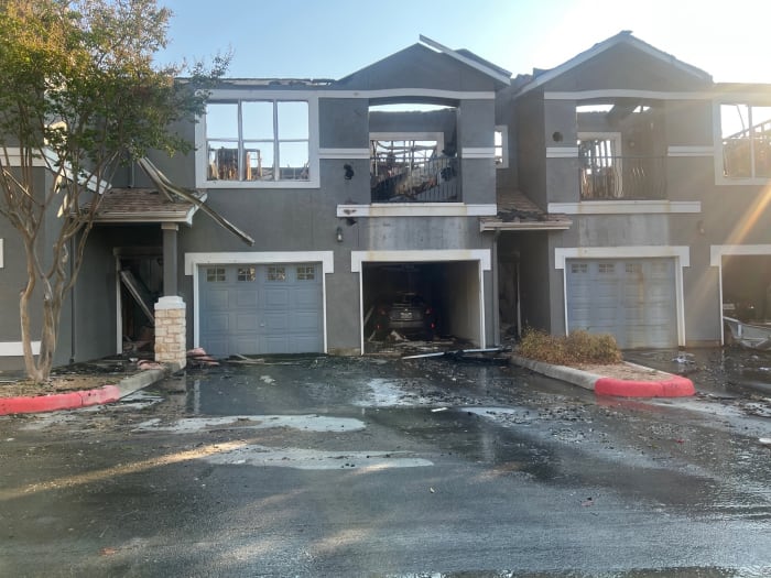 Multiple families displaced after roof of apartment complex collapses in fire officials say