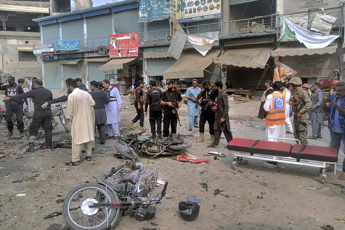 A planted bomb targeting police kills 5 and wounds 20 at a bus stop in northwest Pakistan