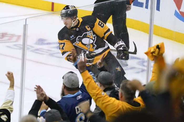 Boston Bruins' Torey Krug gets off a pass as he falls to the ice during the  first period of an NHL hockey game against the Pittsburgh Penguins in  Pittsburgh, Sunday, March 10