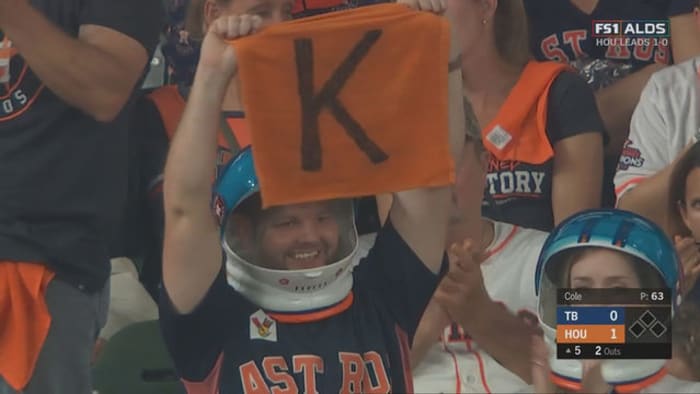 Astros fans wear space helmets behind the plate