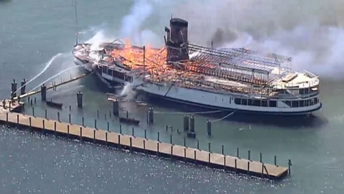 Members of the Detroit Fire Department Marine Corps spray water on the SS  Ste. Claire that was on fire at a marina in Detroit, on Friday, July, 6,  2018. The blaze on