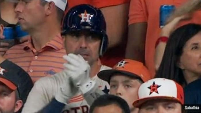 Astros fans wear space helmets behind the plate