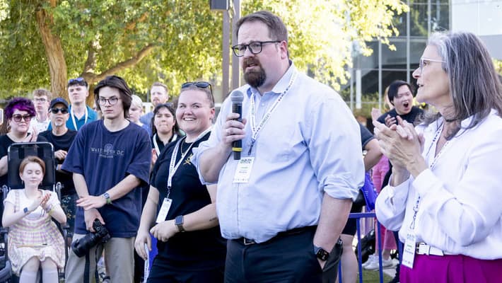 Male design faculty member speaking at Spring 2024's senior design showcase
