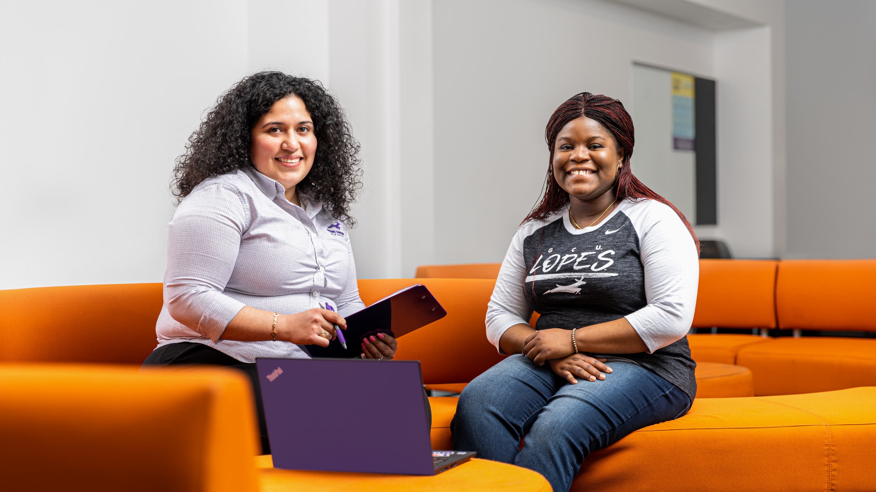 Female financial advisor meeting with GCU nursing student in office lounge