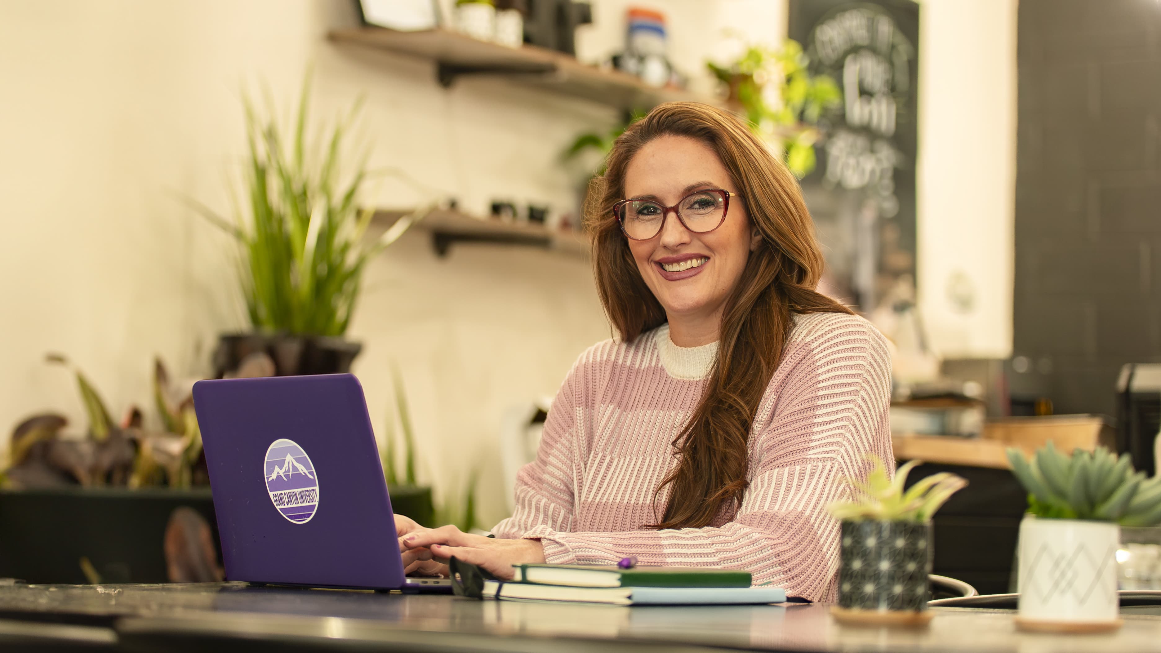 Woman Working in Youth Ministry Sits at Desk and Works on Online Degree