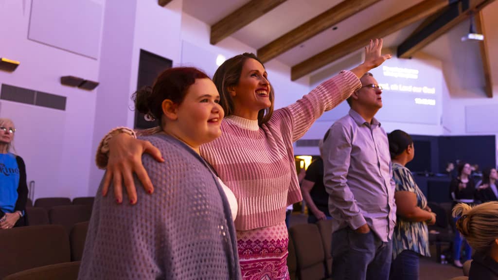 Woman in Youth Ministry Worships With Teen