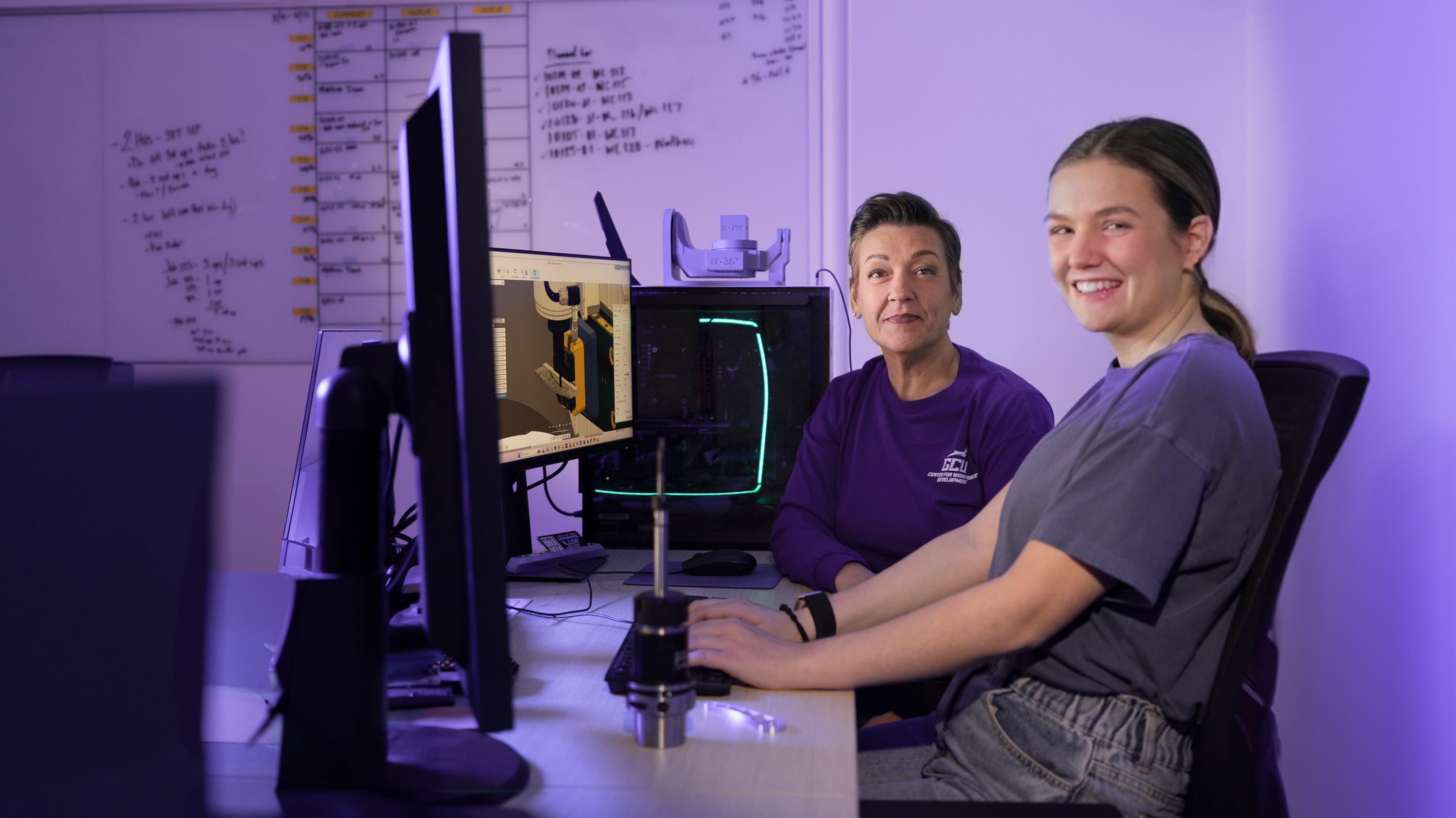 Female BS technology degree student working in GCU computer lab with female instructor