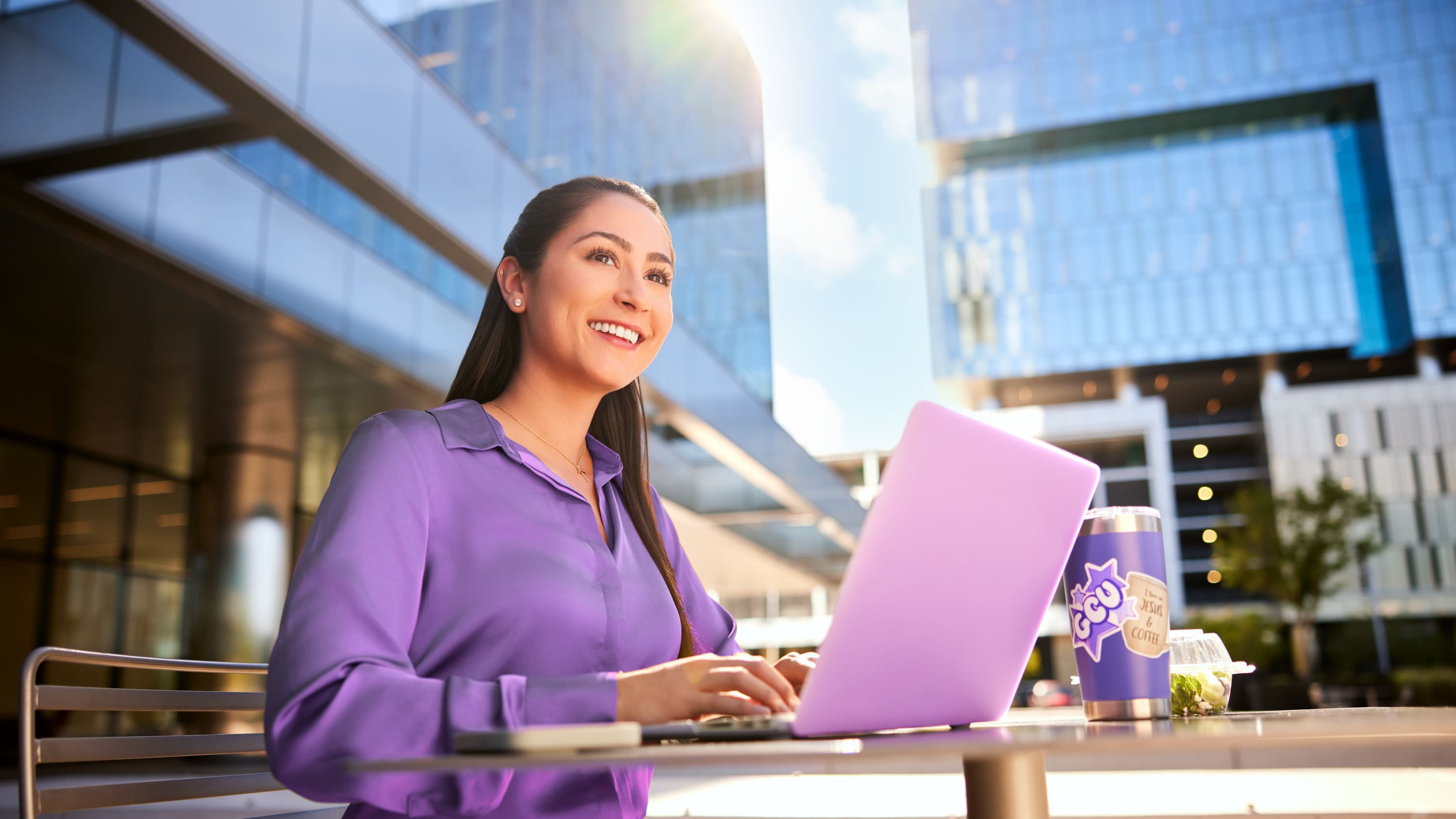 Counselor works on her degree outside on a nice day