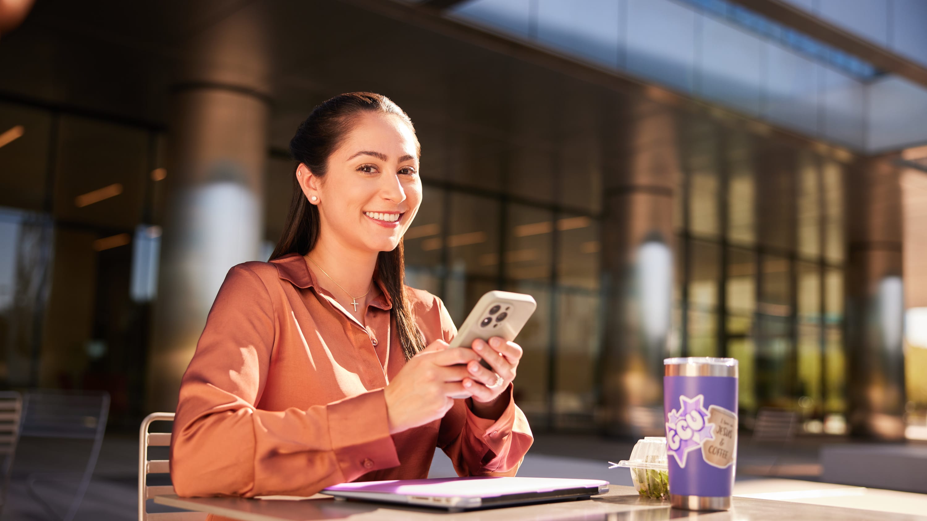 Female DBA degree student earning GCU online degree while working outside