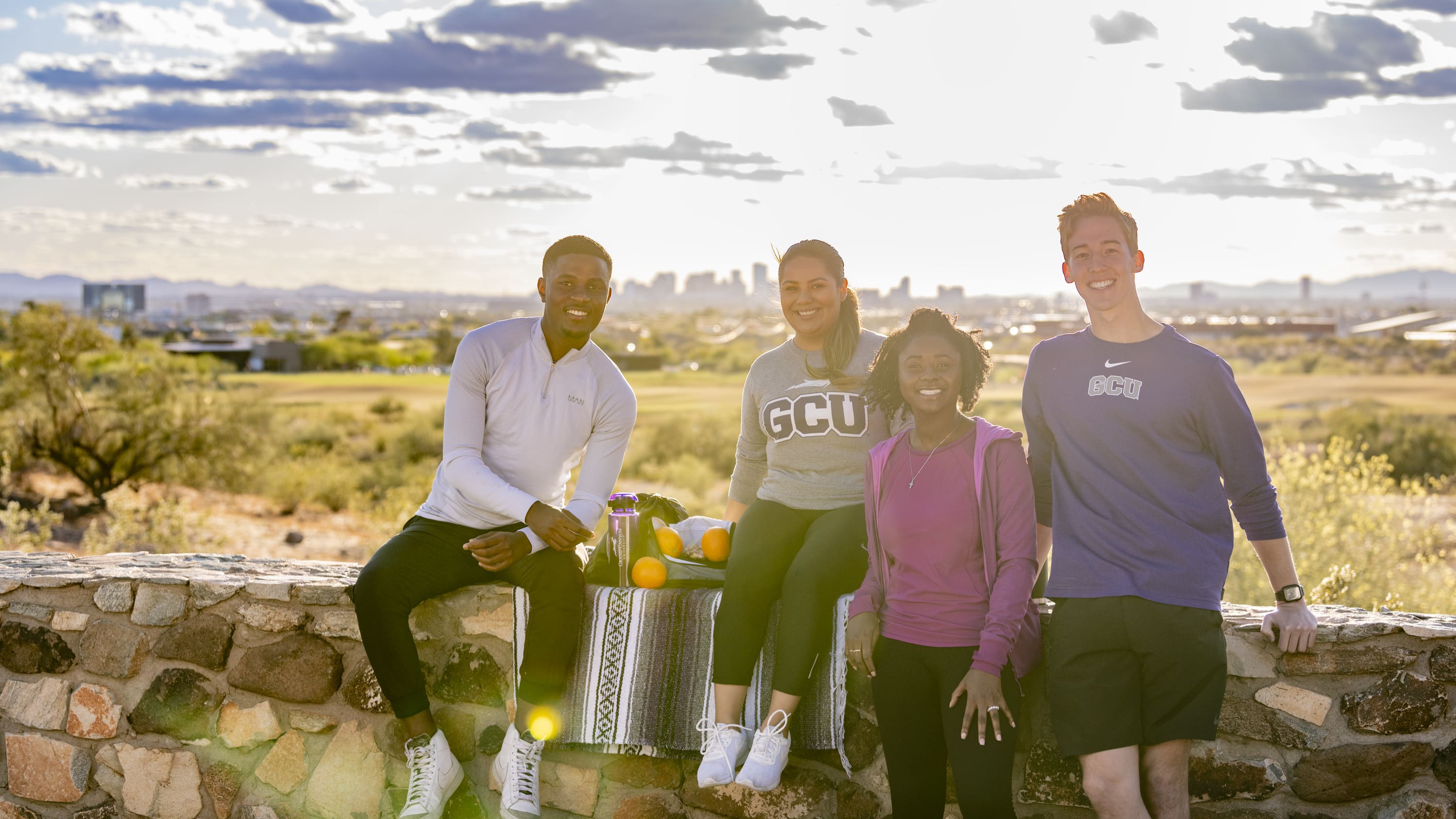 Diverse group of GCU students and faculty sitting outside at Papago Park