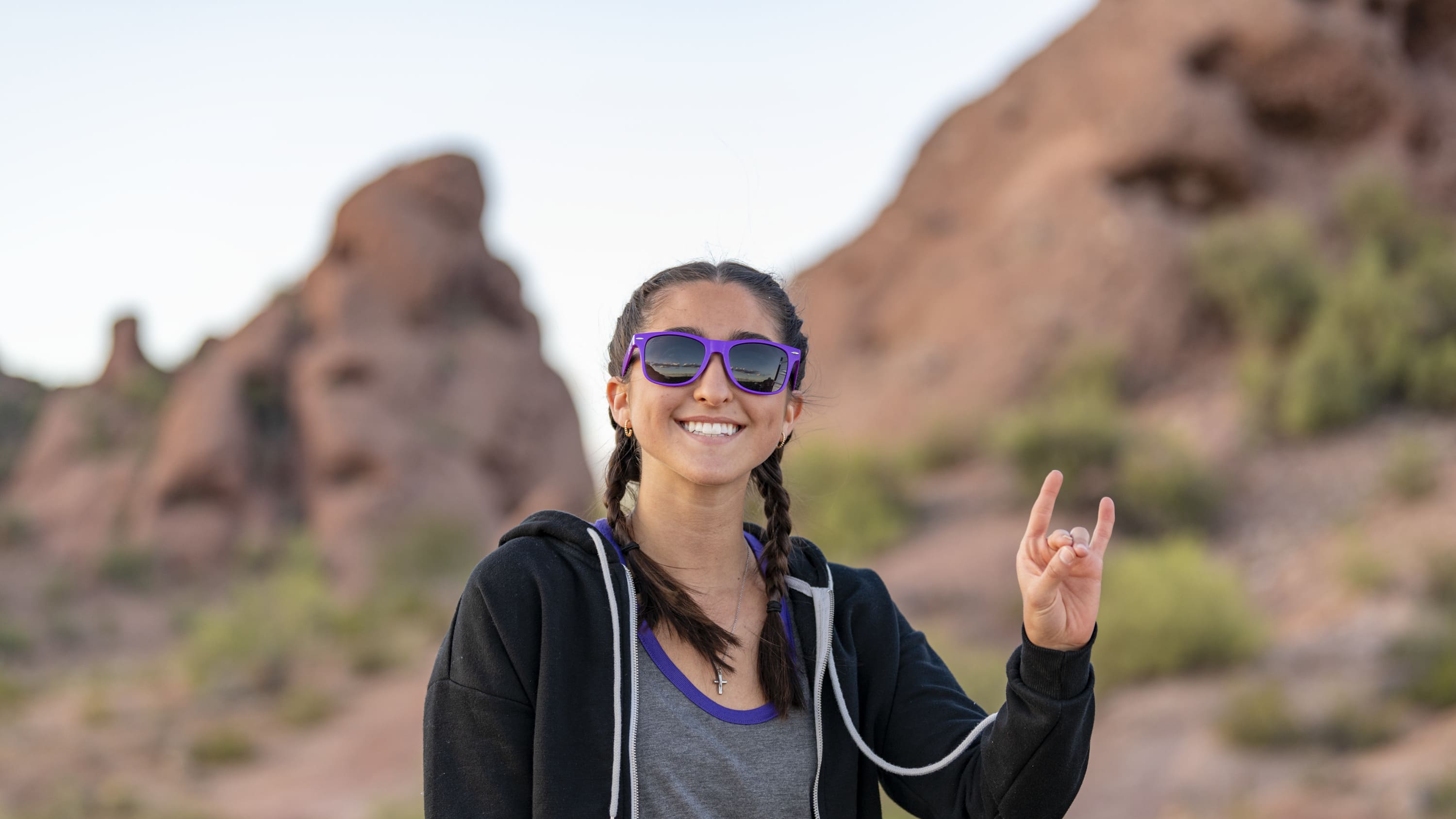Female GCU student smiling with peace sign at Papago Park in Phoenix
