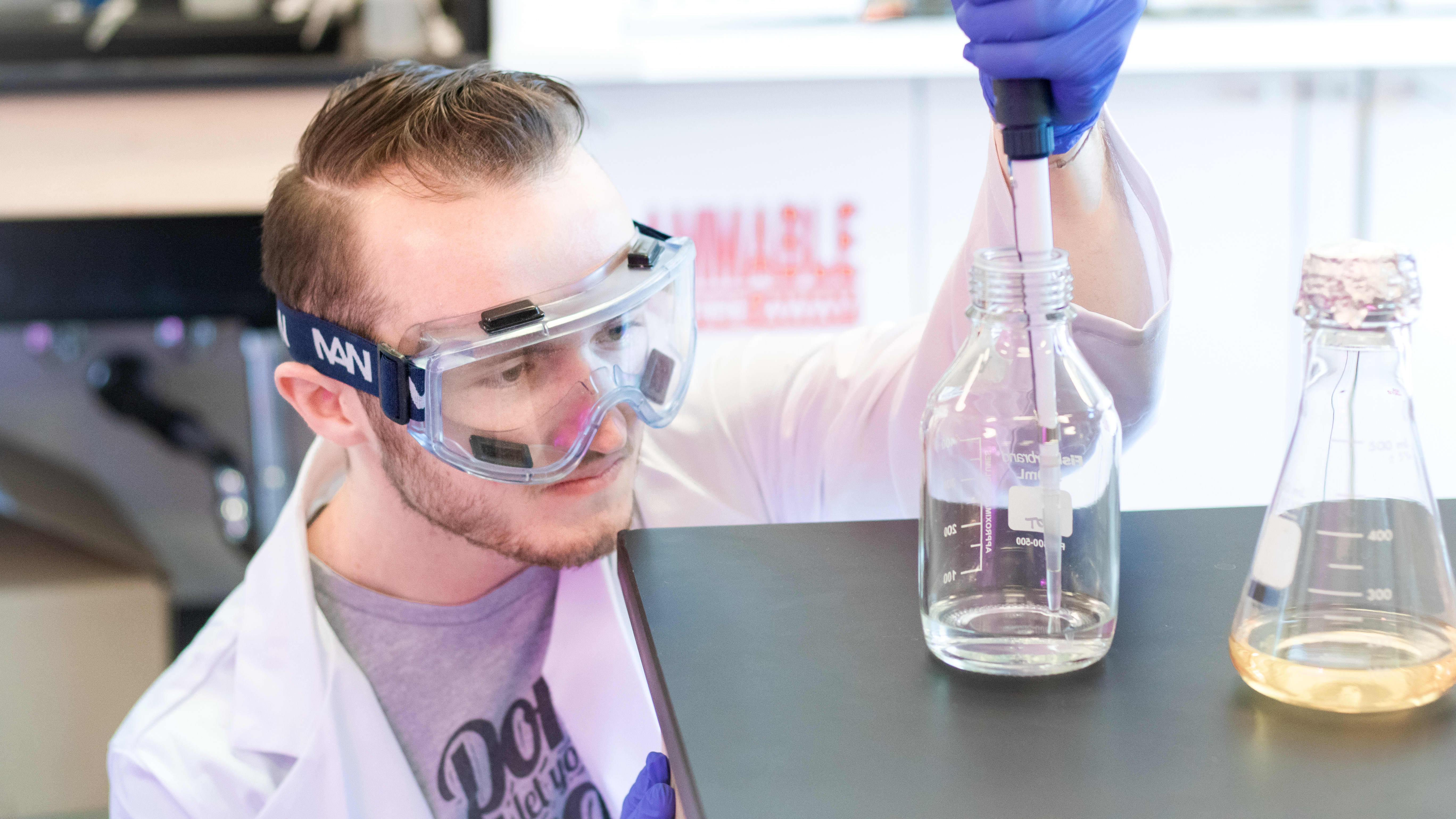 Male science degree student completing lab assignment on GCU's campus