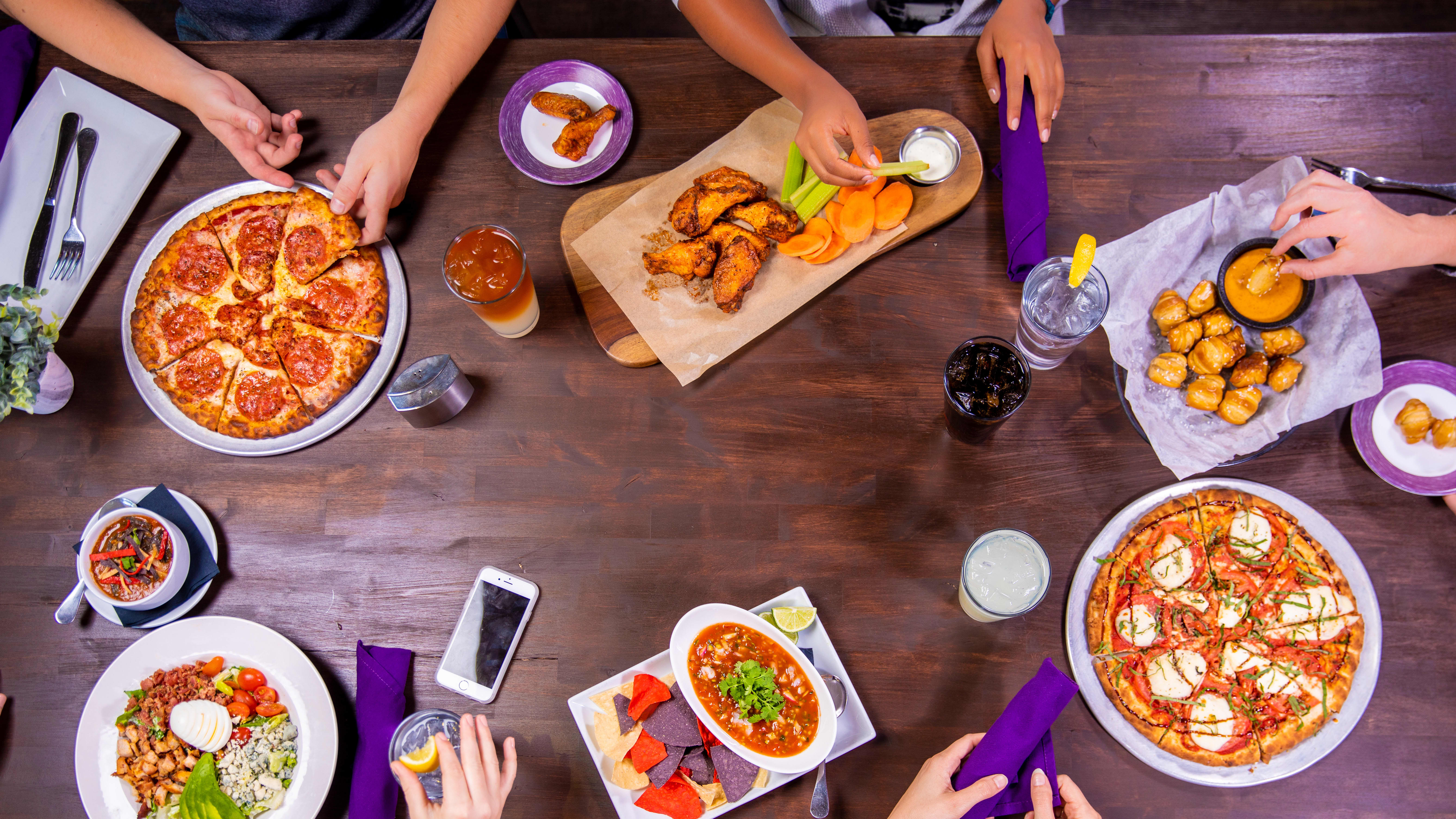 Aerial view of dining table and GCU students eating together on campus