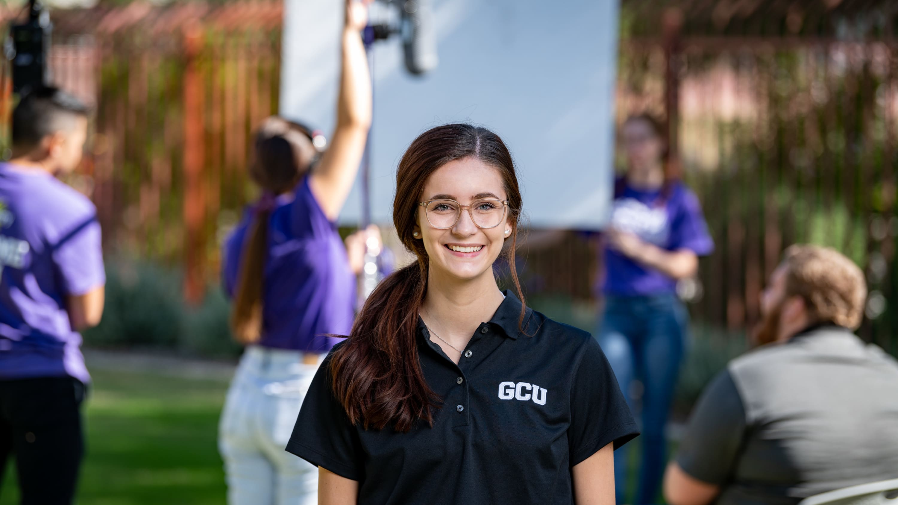 Female bachelor's digital media degree student smiling on set at GCU