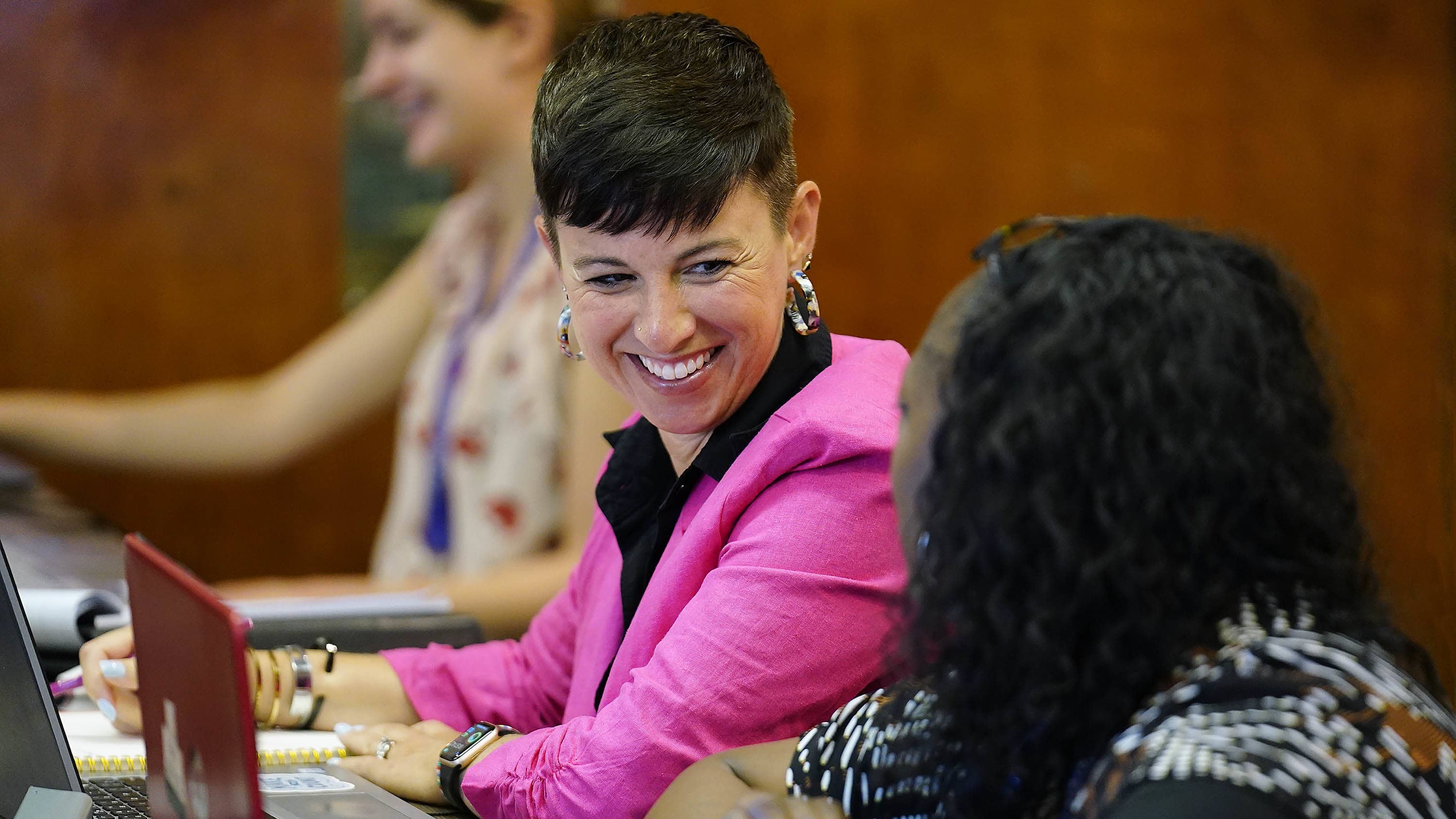 Two women talking at a doctoral studies event