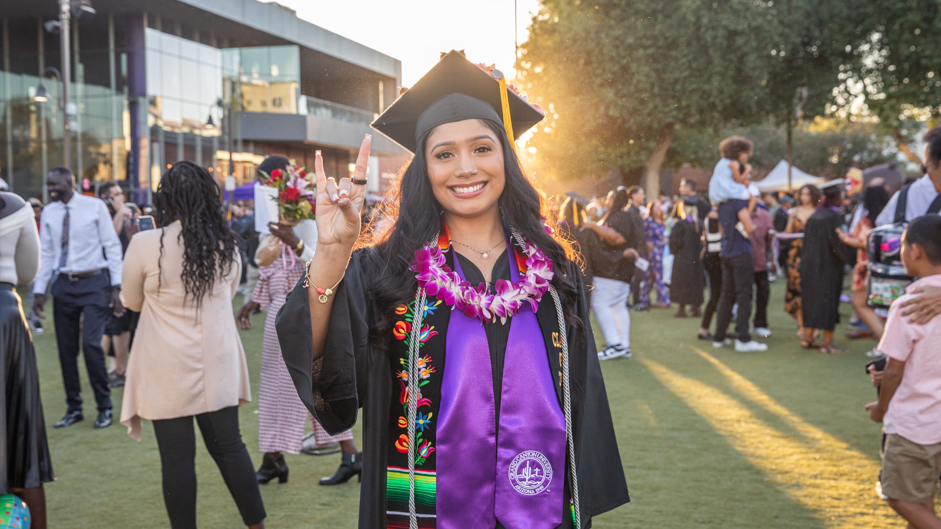 Woman graduating with lopes up