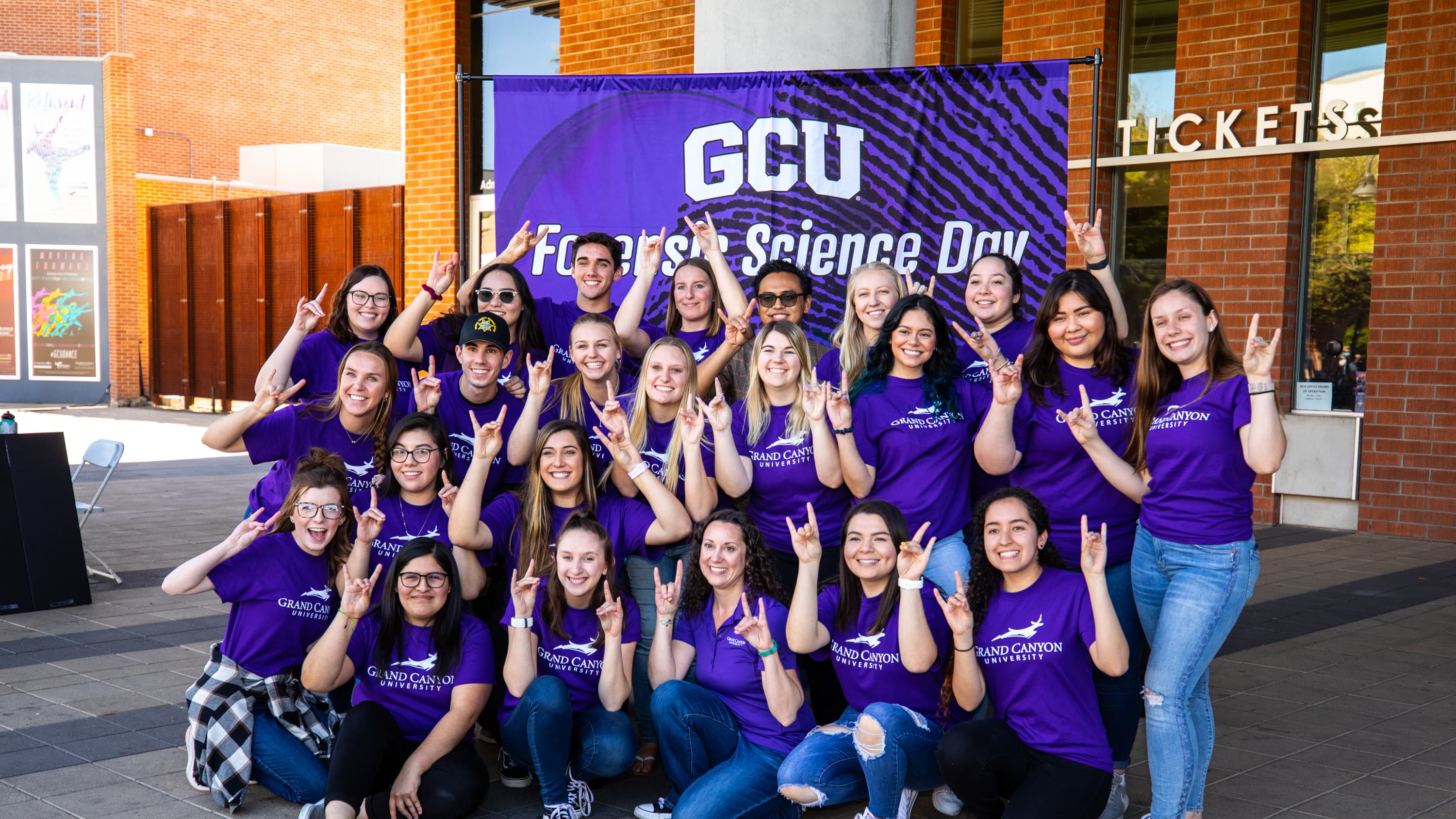 Group of male and female forensic science students smiling for Forensic Science Day at GCU