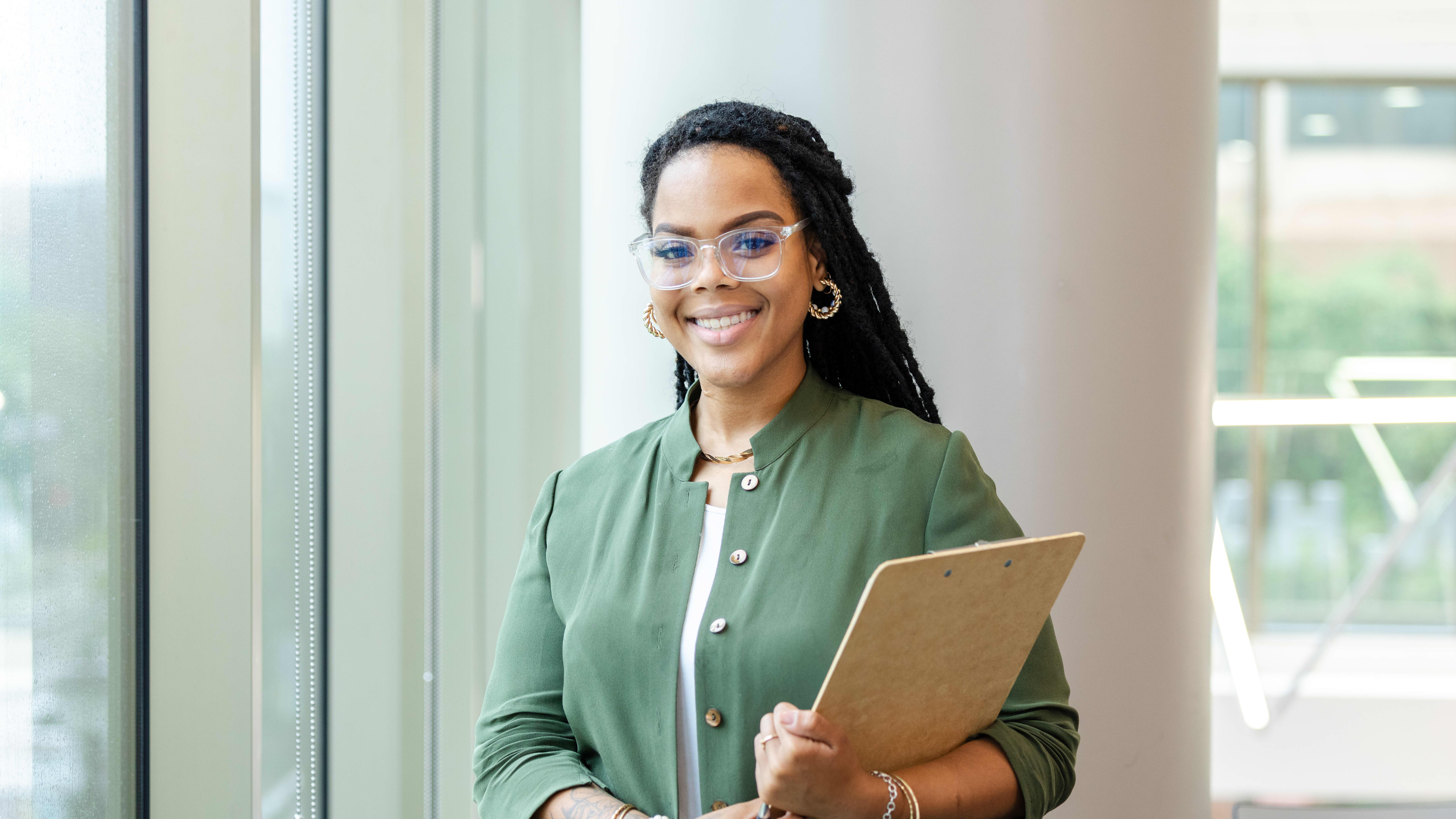 Public Health Worker Stands Smiling at Job After Earning Her Master of Public Health (MPH) Degree from GCU