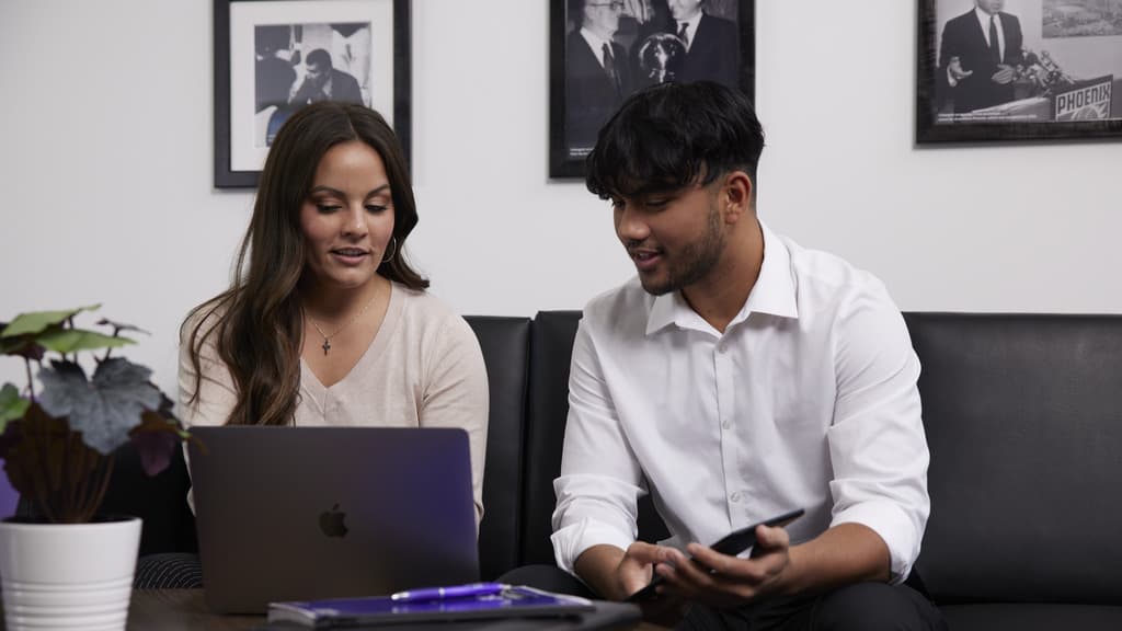 GCU Business Students Sit and Work Together