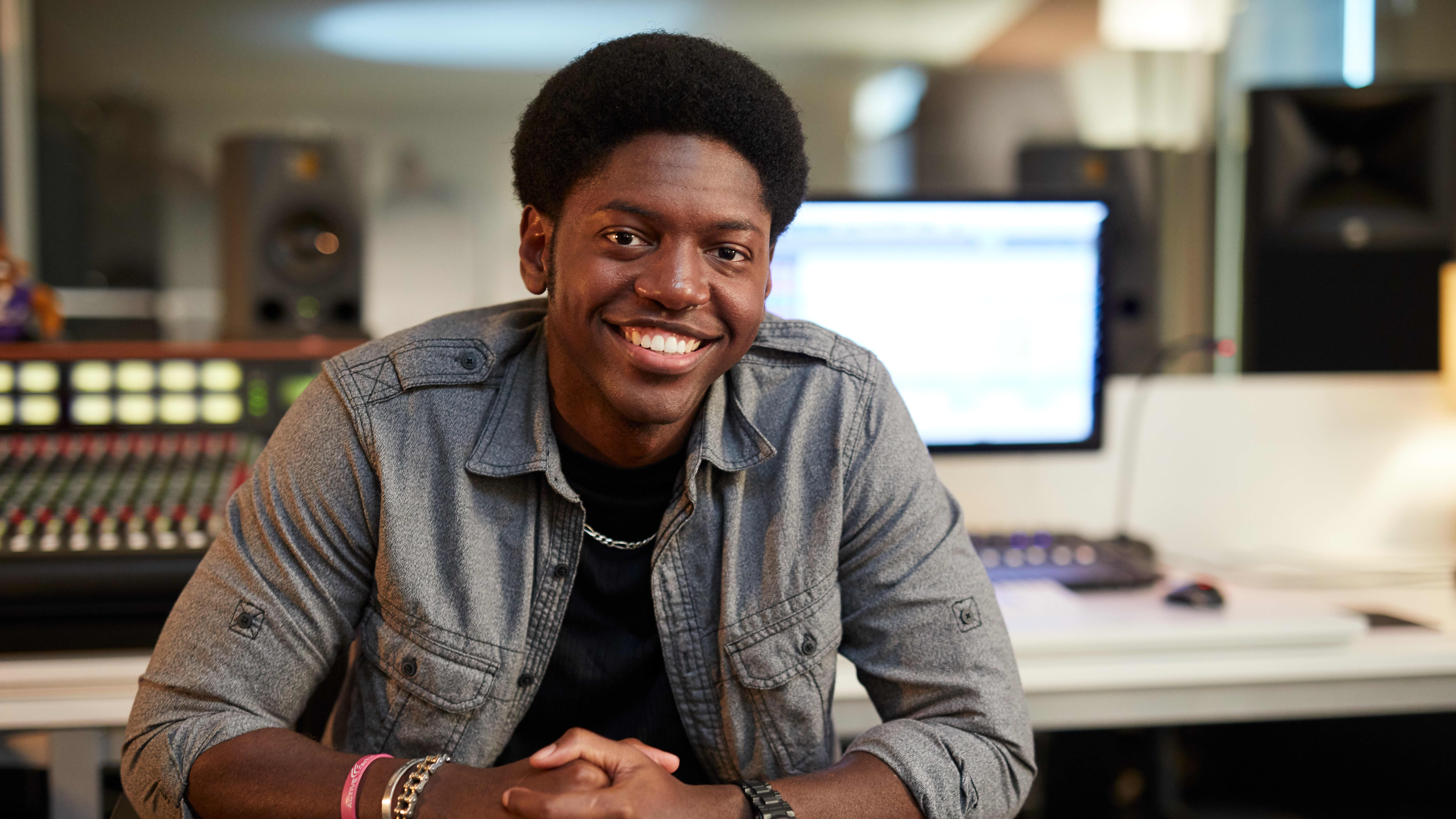 Male digital media degree student working on project in computer lab