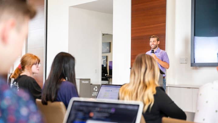 Male and female communications degree students in class at GCU