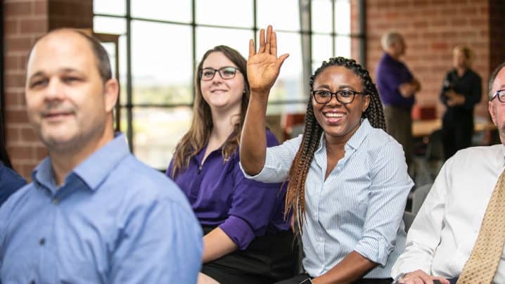 Female language degree student raising her hand in class at GCU