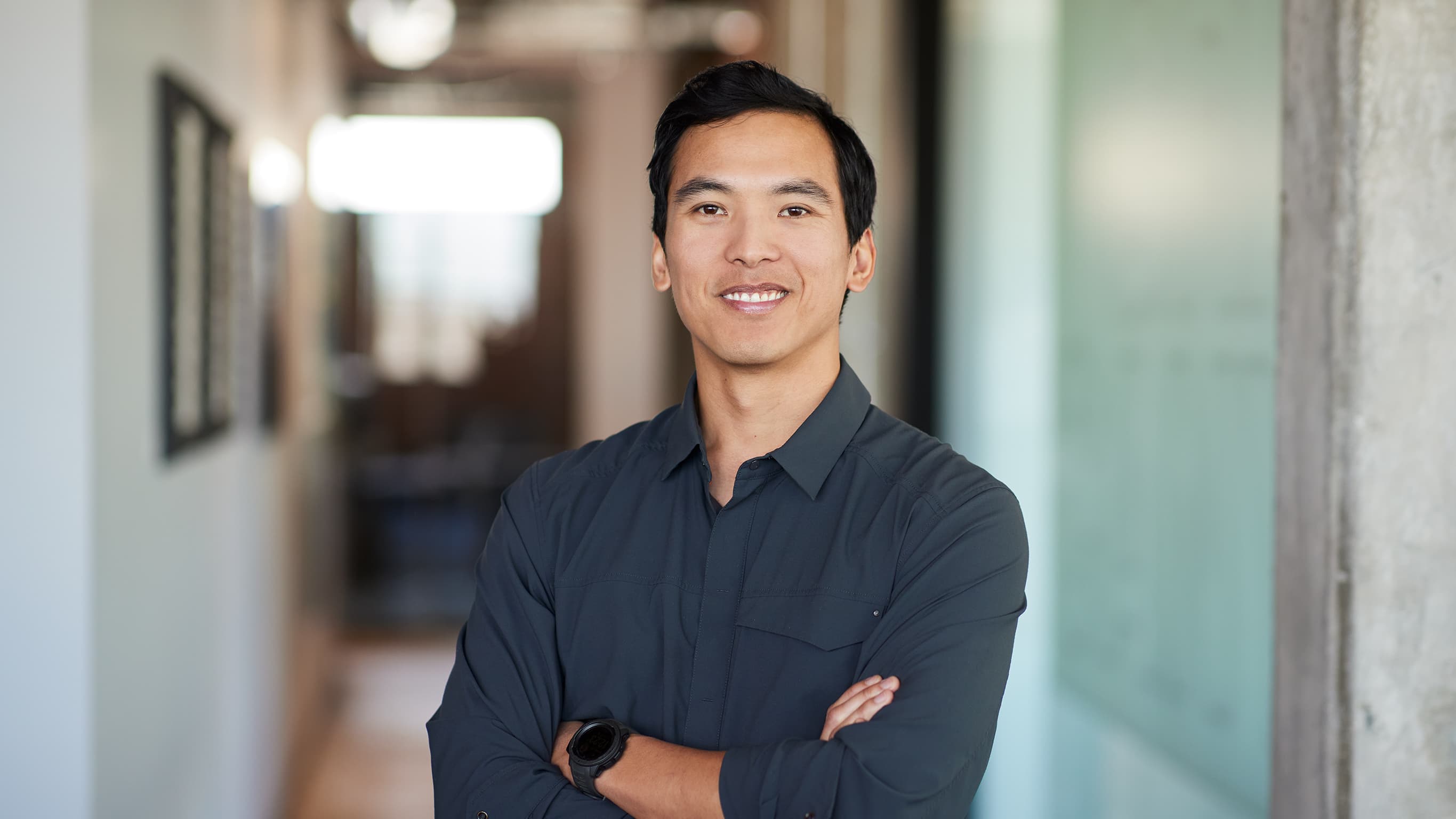 A GCU master's student smiling while standing in hallway