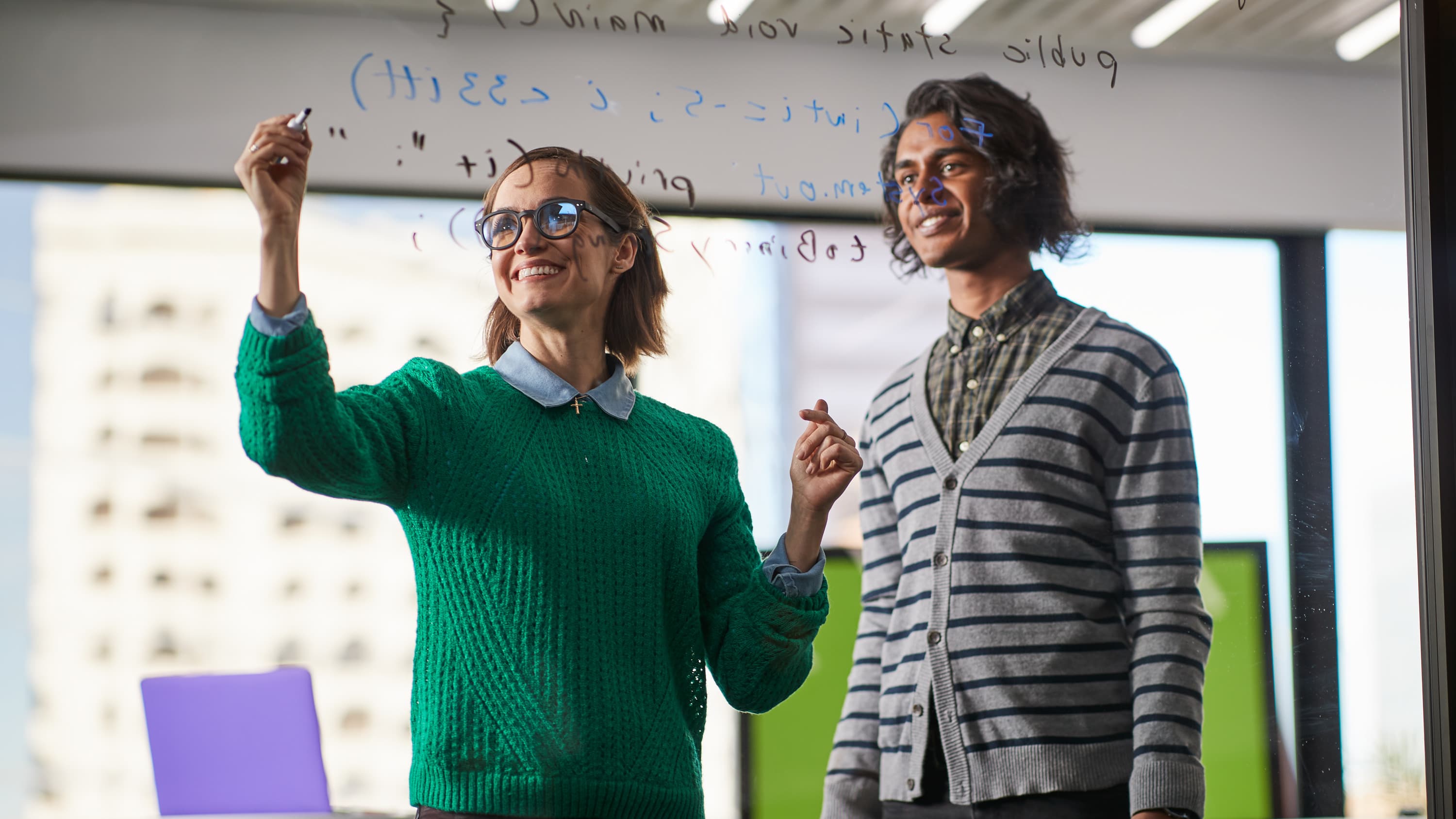 Male and female master's science degree students completing lab assignment