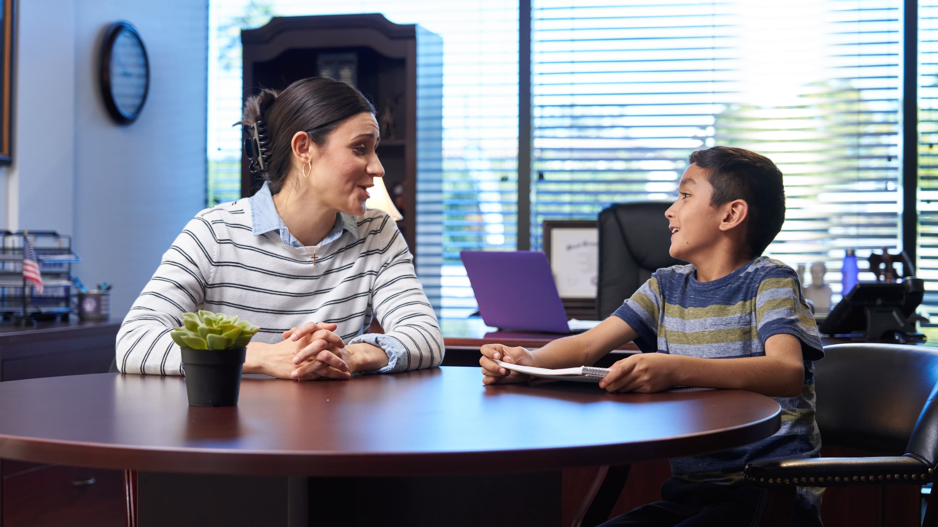 MSW degree graduate working as social worker with young child in office