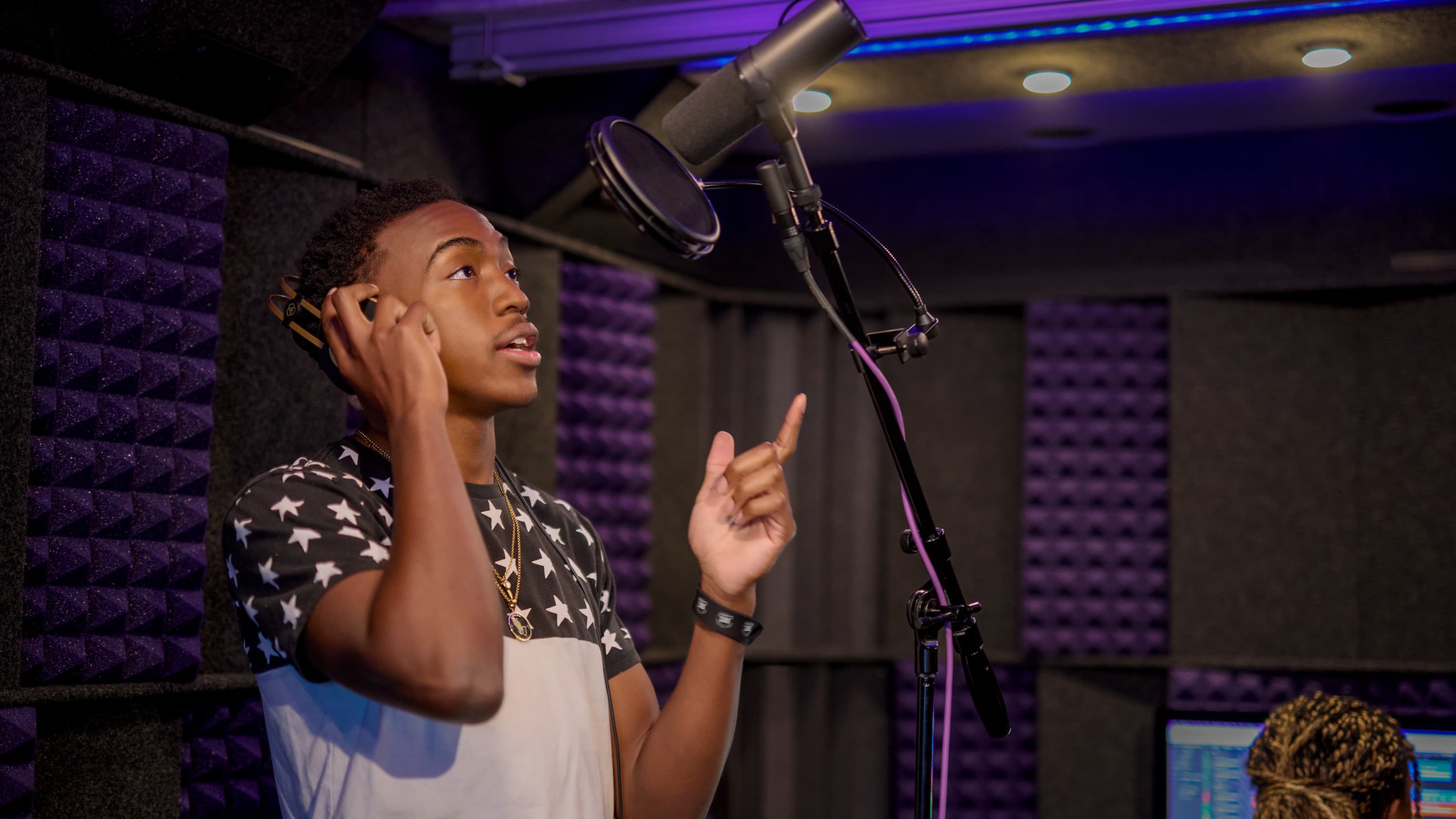 student singing in the recording studio